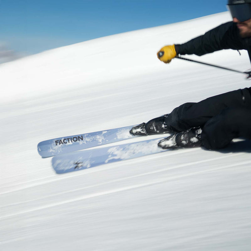 Skier carving on gray Faction Dancer 1 piste skis 2026