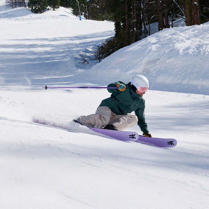 Girl skier carving on purple Dancer 2 all-mountain skis 2026
