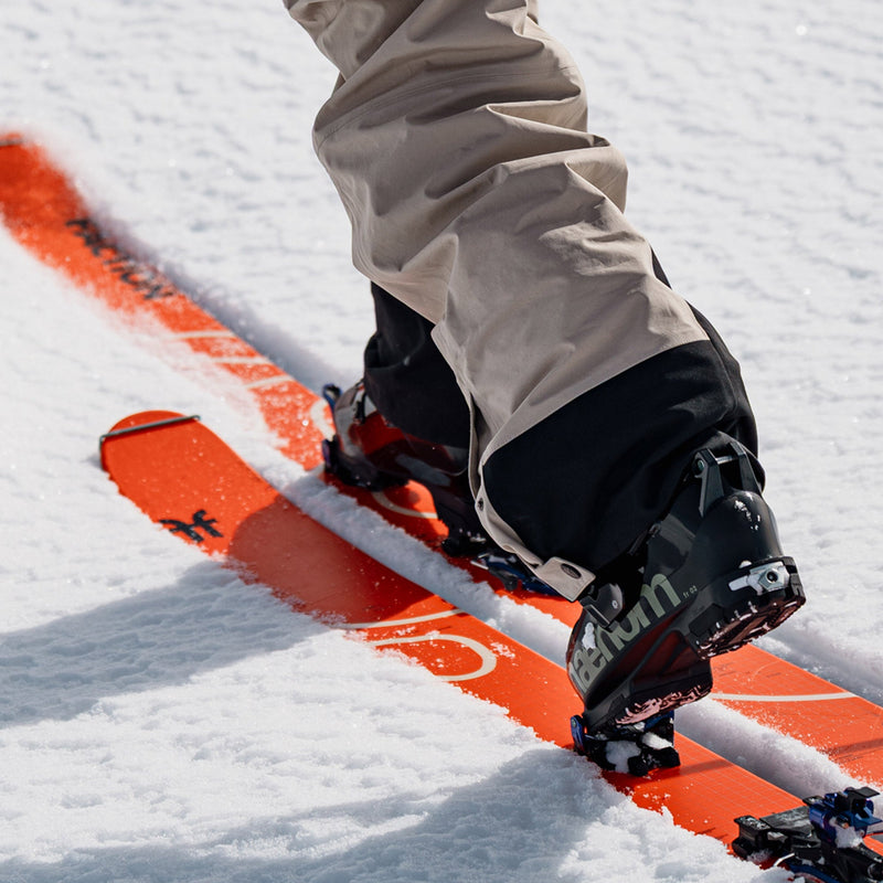 Skier touring with black and green freeride and touring ski boots phaenom fr 130 and orage Faction touring skis Agent 3