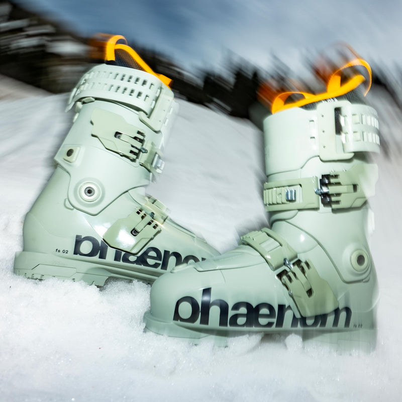 Green and yellow phaenom fs 02 90 freestyle and allmountain ski boots on snow