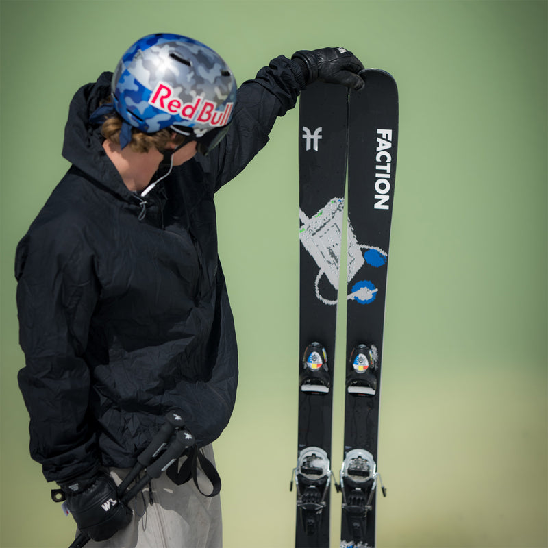 Mac Forehand admiring the Faction Prodigy 1 black skis.
