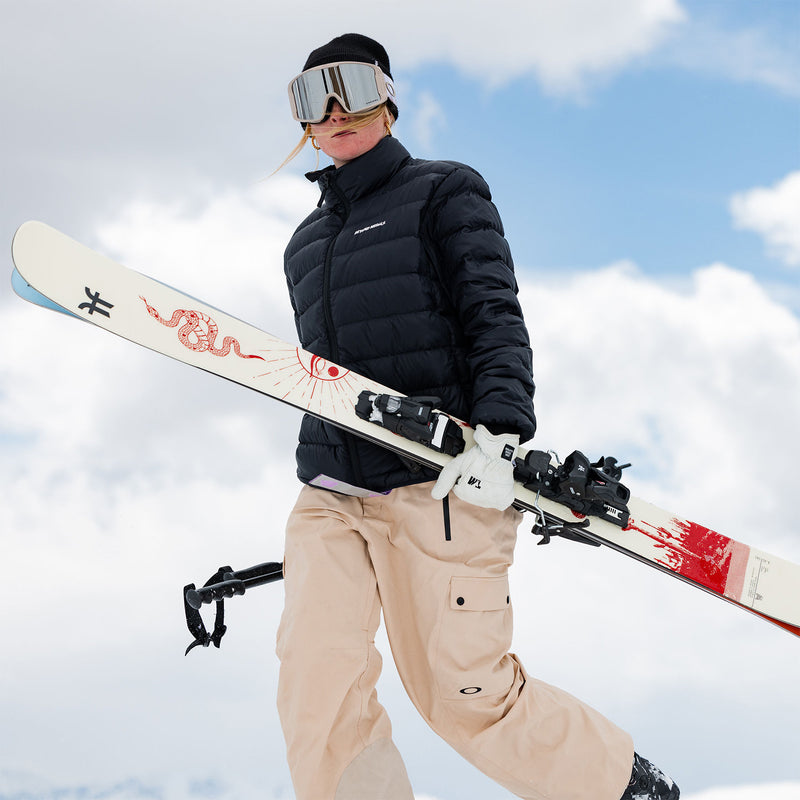 Women carrying Faction Prodigy 3 Capsule white ski.