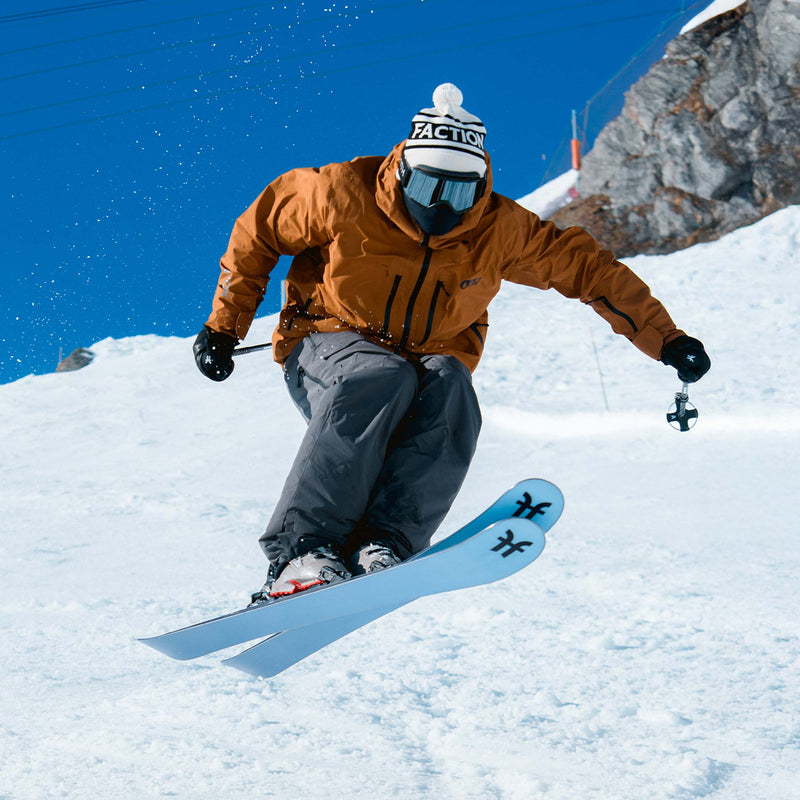 Skier jumping on blue Faction Dancer 2 all-mountain skis 2026