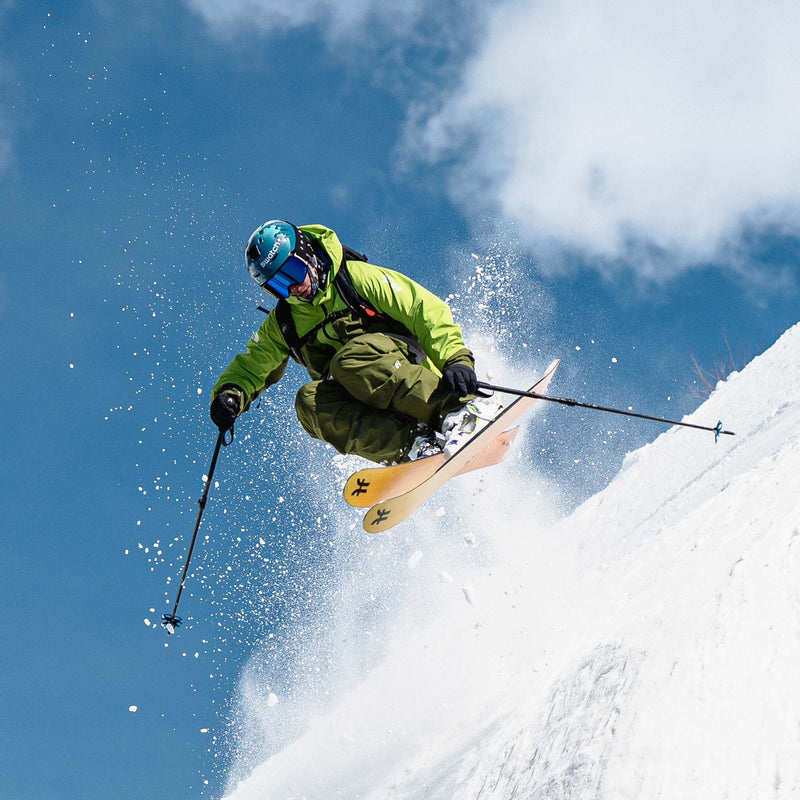 Freeride skier jumping on yellow Dancer 4 Freeride and powder skis 2026