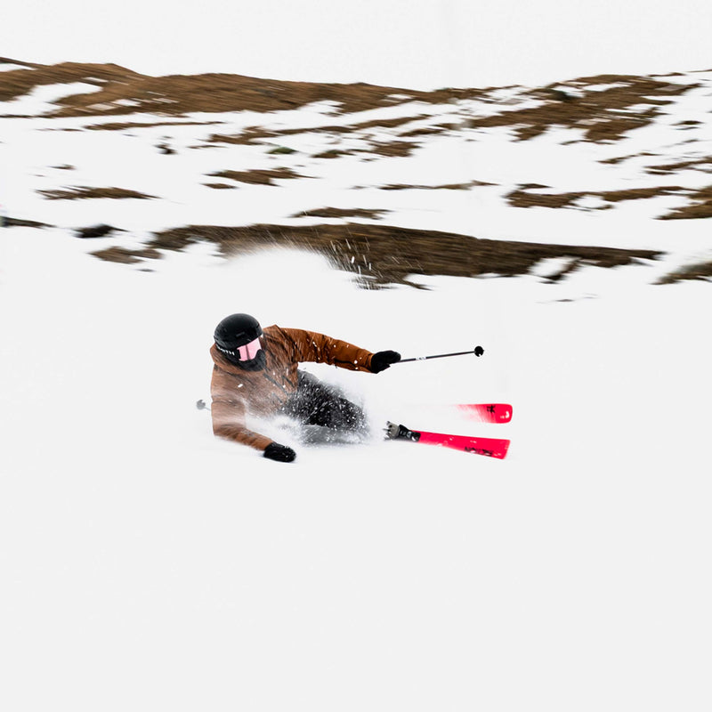 Skier carving on red and pink Faction Dancer 79 piste ski 2026