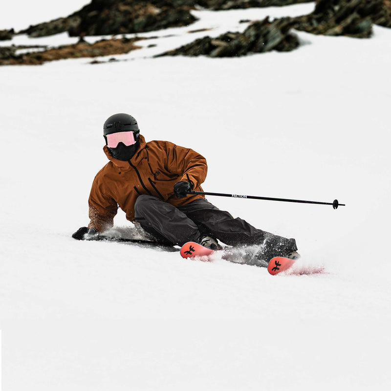 Skier carving on red and pink Faction Dancer 79 piste ski 2026