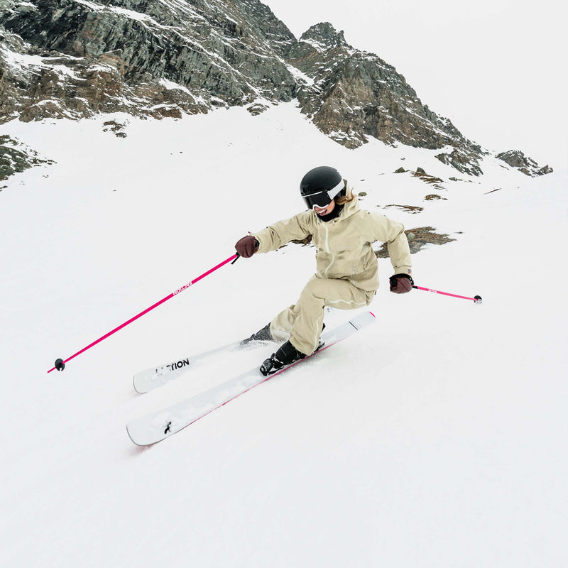 Skier carving on white and pink Faction Dancer 79 piste ski 2026