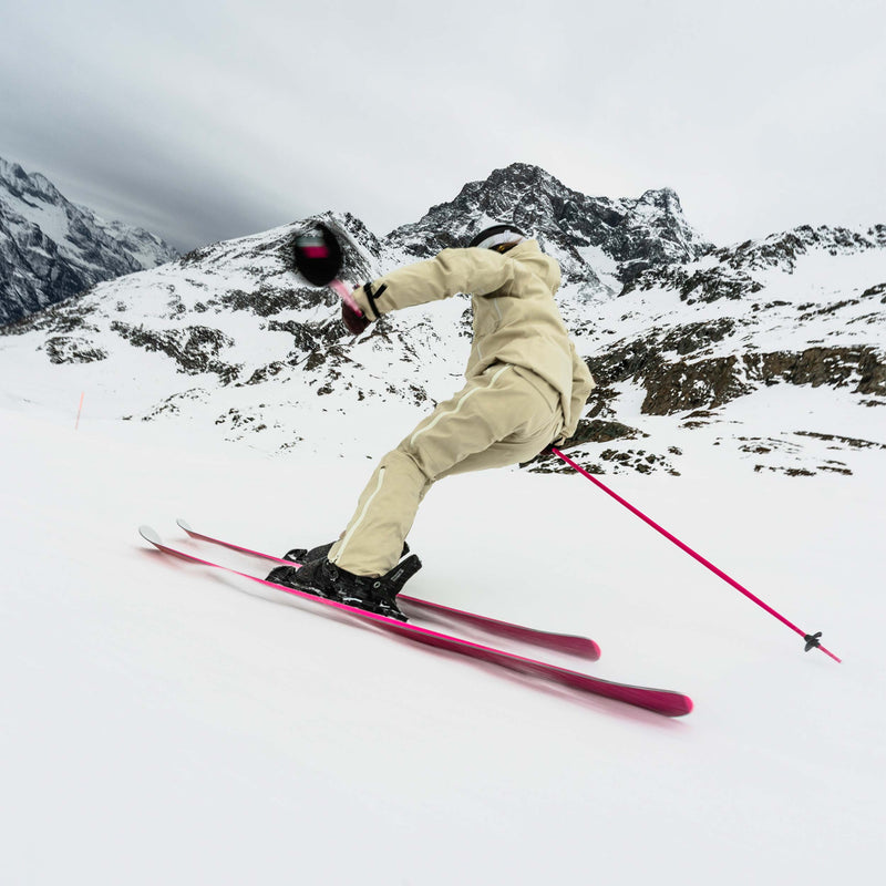 Skier carving on white and pink Faction Dancer 79 piste ski 2026