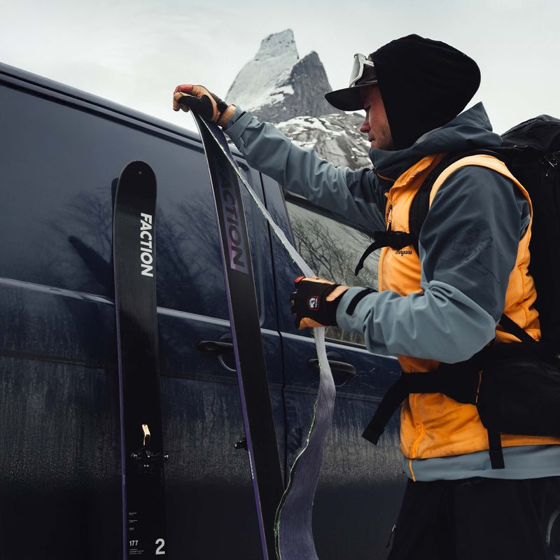 Skier putting skins on Faction La Machine 2 touring skis 2026