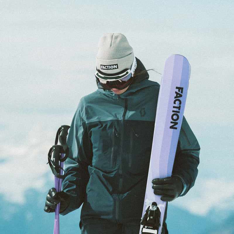 Skier wearing Faction skis logo beanie in grey