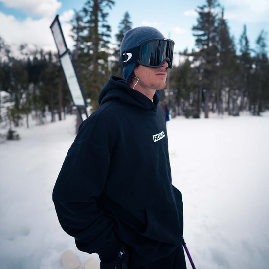 Faction skier wearing black Faction logo hoodie
