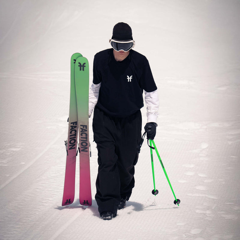 Faction freestyle skier walking wearing Faction t-shirt