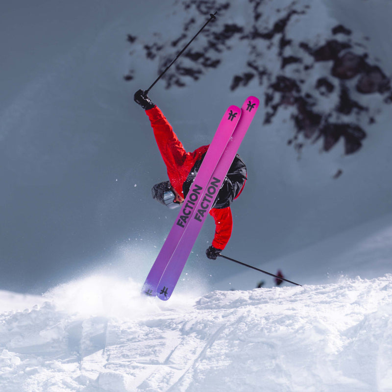 Freeski skier riding powder with black and purple all-mountain Freeski Faction Prodigy 3 ski