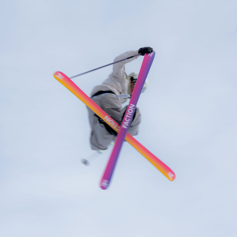 Freestyle skier jumping and grabbing yellow and purple freestyle Faction Studio 0 ski 2026
