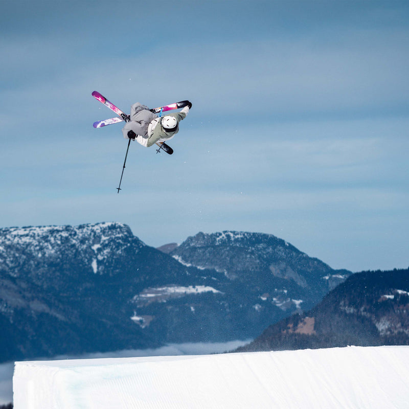 Freestyle skier jumping and grabbing yellow and purple freestyle Faction Studio 0 ski 2026