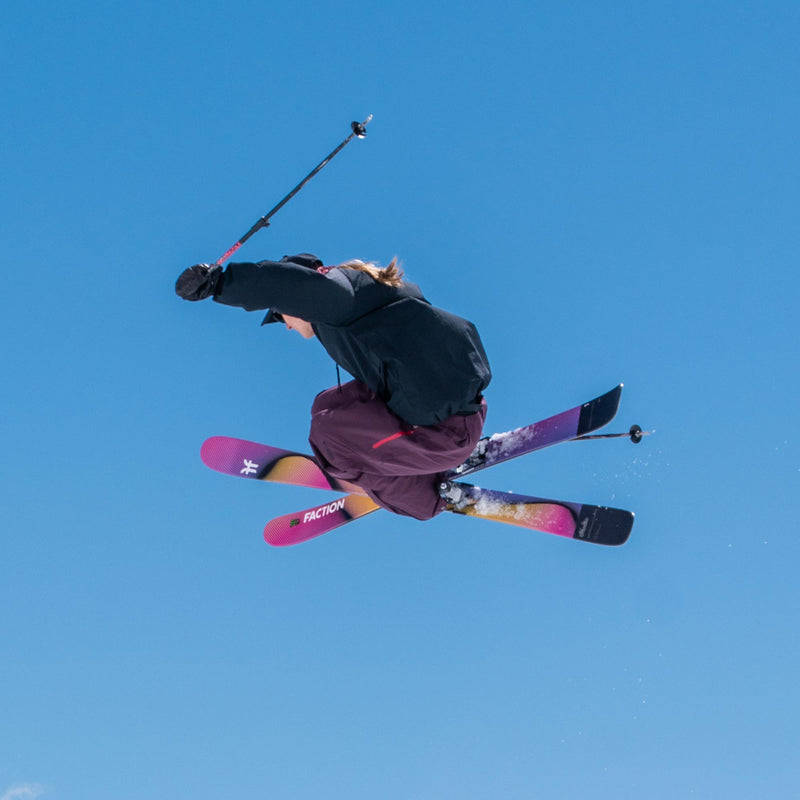 Freestyle skier jumping and grabbing yellow and purple freestyle Faction Studio 1 ski 2026