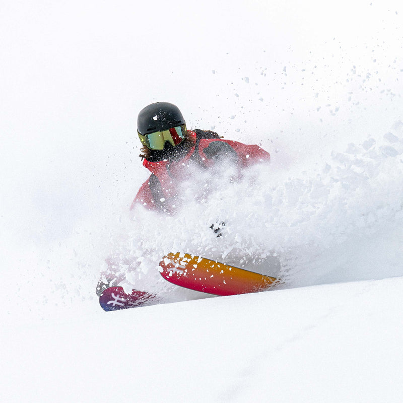Freeride skier riding powder with yellow and purple powder and freeride Faction Studio 4 ski 2026