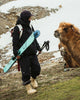 Woman standing in front of Camel with Faction Agent 3 skis