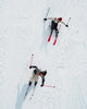 Two people skiing on a snowy landscape from an aerial perspective