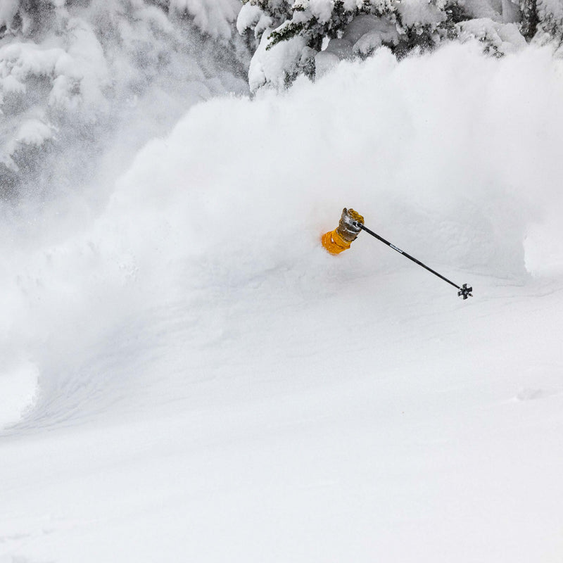 Skier riding deep powder with Black Faction poles