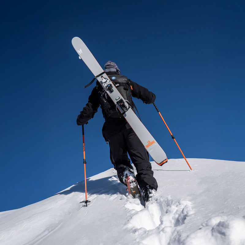 Skier walking uphill with Faction La Machine Skis