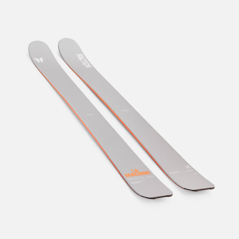 Two gray Faction skis with orange branding on a white background