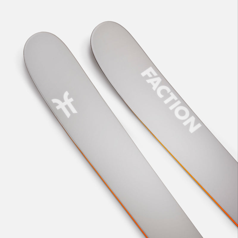 Two gray Faction skis on a white background