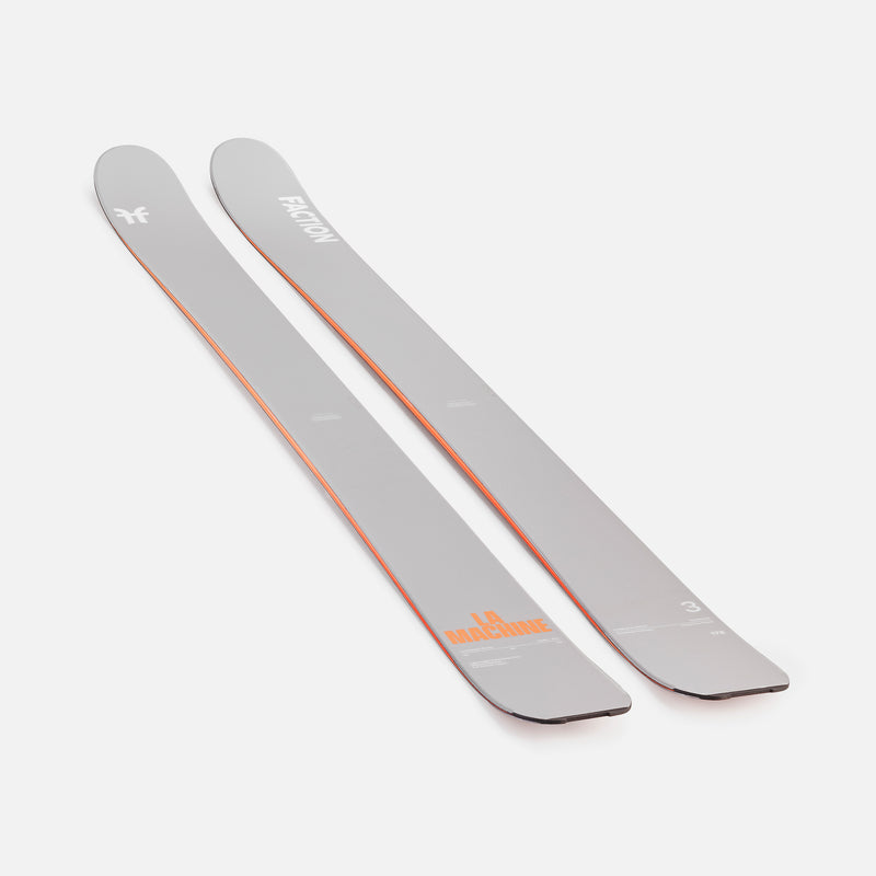 Two gray Faction skis with orange branding on a white background