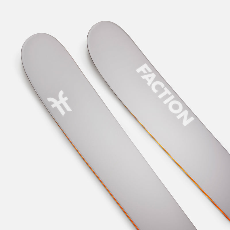 Two gray Faction skis on a white background