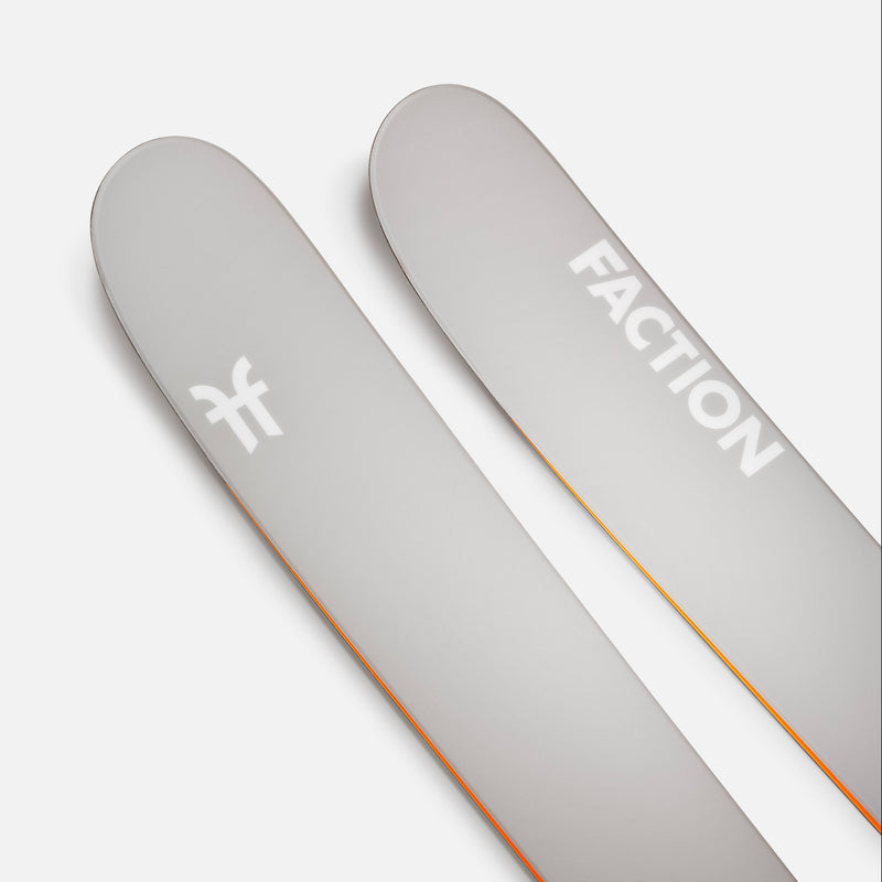Two gray Faction skis on a white background