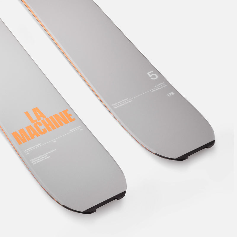 Two gray skis with orange text on a white background