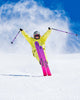 Person skiing with a yellow jacket and pink skis against a snowy background